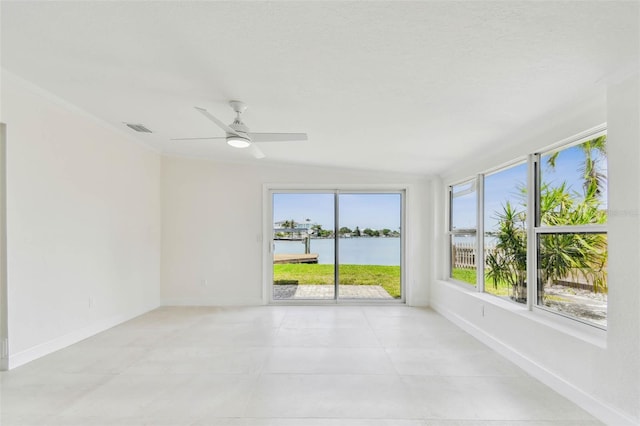 unfurnished room featuring a water view, ceiling fan, baseboards, and light tile patterned floors