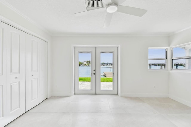 unfurnished bedroom featuring crown molding, access to outside, french doors, baseboards, and a water view