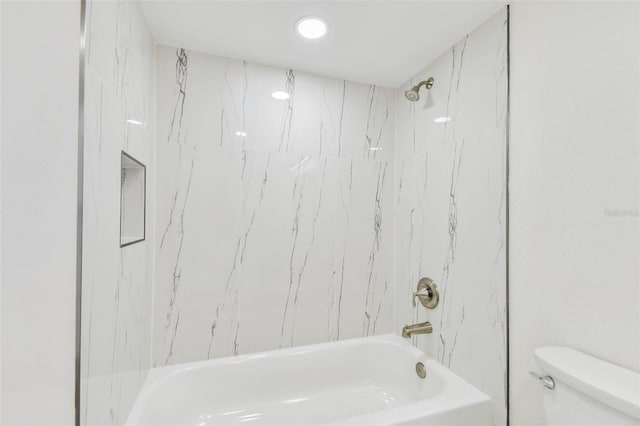bathroom with toilet and bathing tub / shower combination