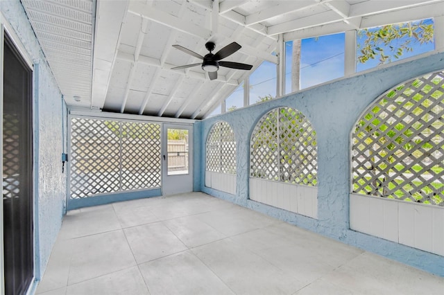 unfurnished sunroom with a ceiling fan