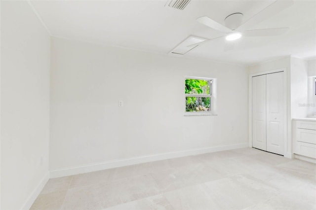 unfurnished room with baseboards and a ceiling fan