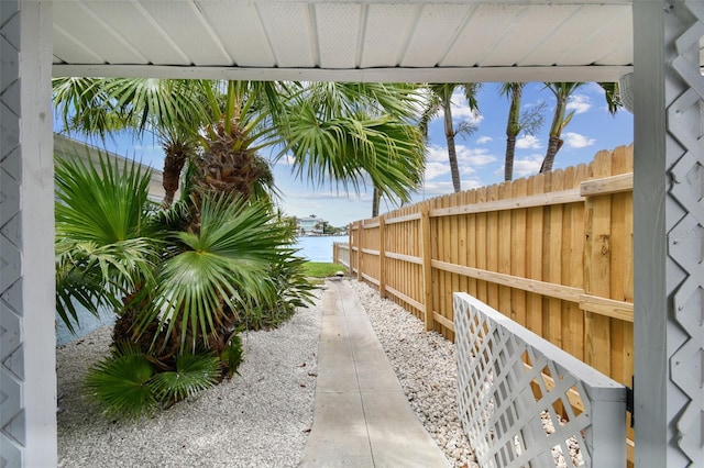 view of yard with fence and a water view