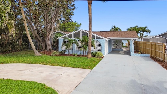 mid-century inspired home with driveway and a carport