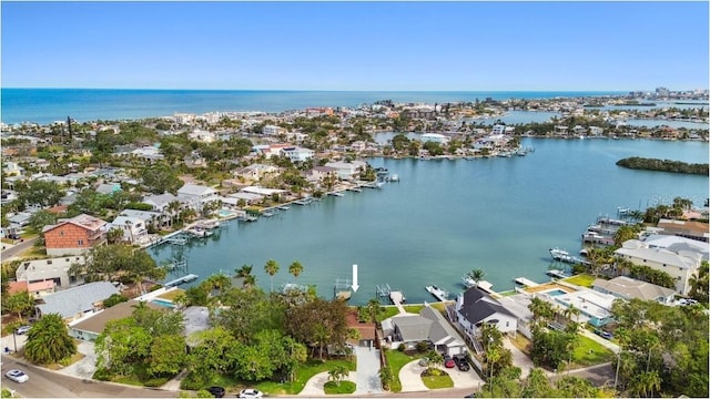 aerial view of residential area featuring a large body of water