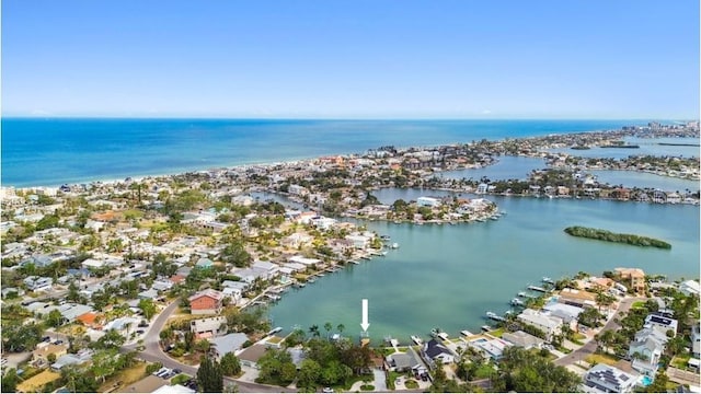 aerial view of property's location featuring a large body of water and nearby suburban area