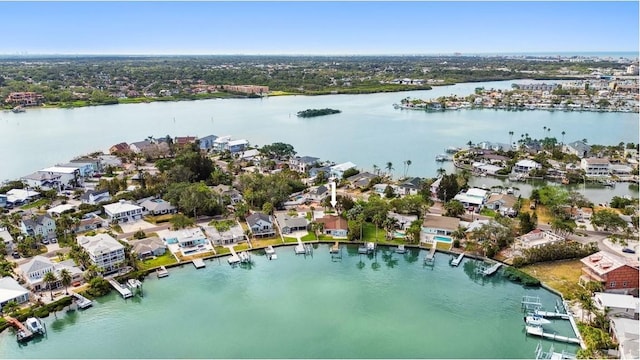 aerial view of property's location featuring a large body of water and nearby suburban area