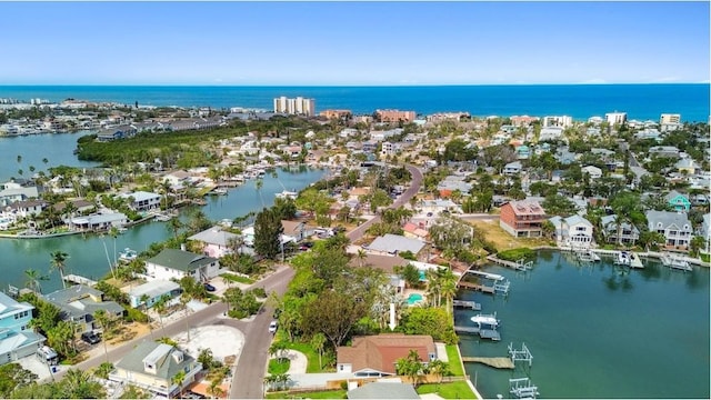 aerial overview of property's location with a nearby body of water and nearby suburban area