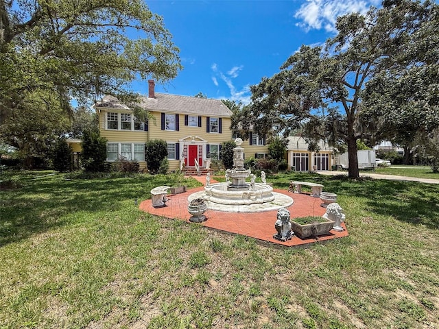 800 W Lake Elbert Dr NE, Winter Haven, FL 33881 - view of front of home with a chimney and a front lawn