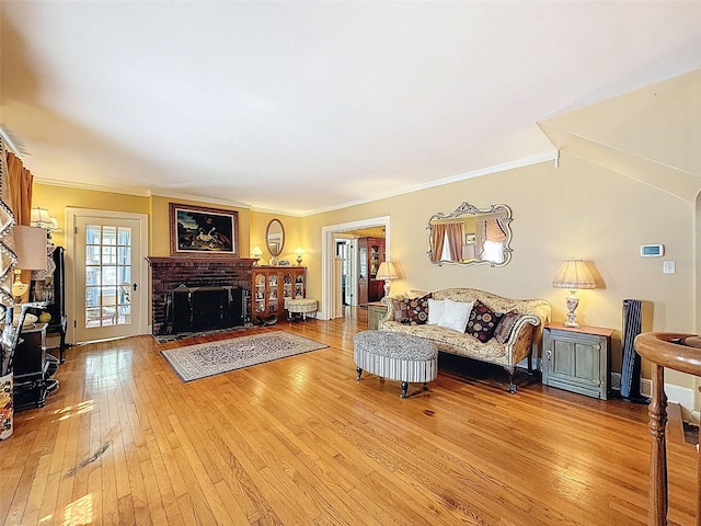 800 W Lake Elbert Dr NE, Winter Haven, FL 33881 - living room featuring light wood-style floors, a brick fireplace, and crown molding