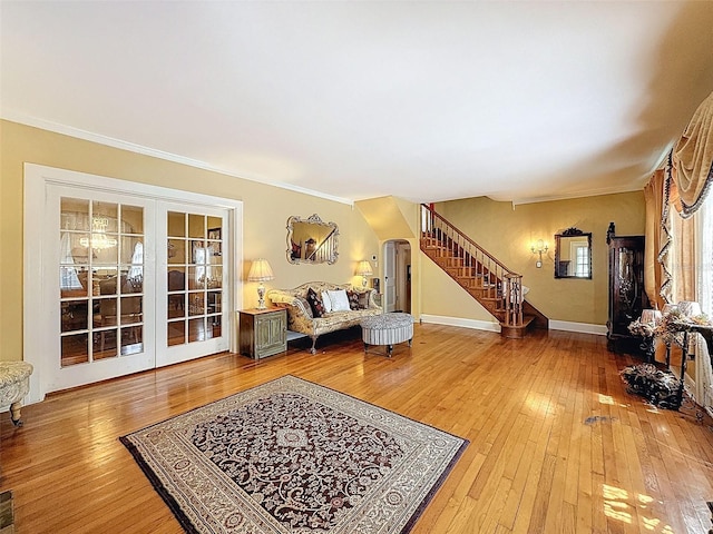 800 W Lake Elbert Dr NE, Winter Haven, FL 33881 - living area featuring stairs, wood-type flooring, french doors, crown molding, and arched walkways