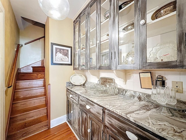 800 W Lake Elbert Dr NE, Winter Haven, FL 33881 - bar with wood finished floors, stairs, and tasteful backsplash