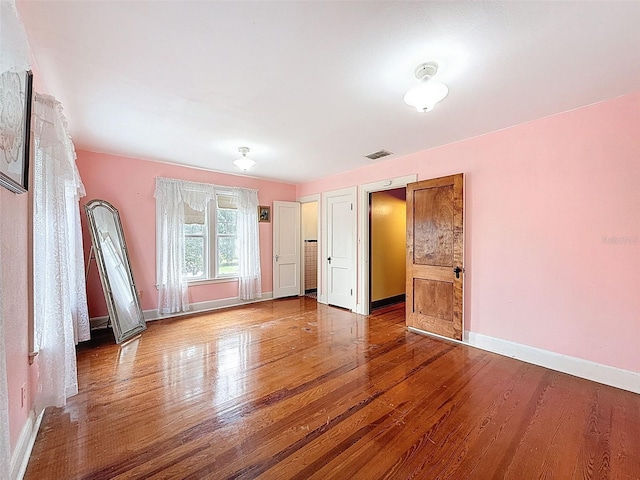 800 W Lake Elbert Dr NE, Winter Haven, FL 33881 - unfurnished bedroom featuring wood finished floors and baseboards