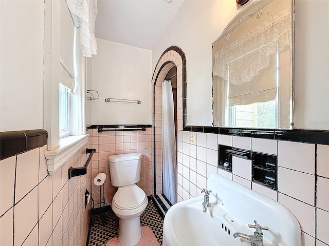 800 W Lake Elbert Dr NE, Winter Haven, FL 33881 - full bathroom featuring tile walls, a shower with shower curtain, a wainscoted wall, and tile patterned floors