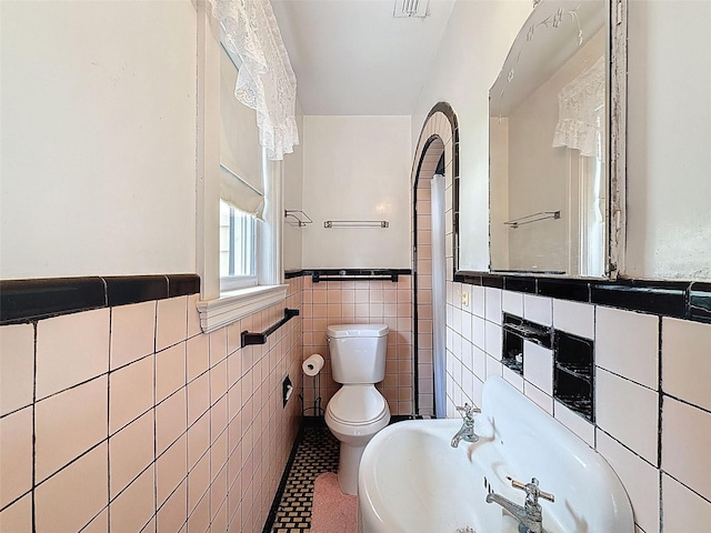 800 W Lake Elbert Dr NE, Winter Haven, FL 33881 - bathroom with tile walls and a wainscoted wall