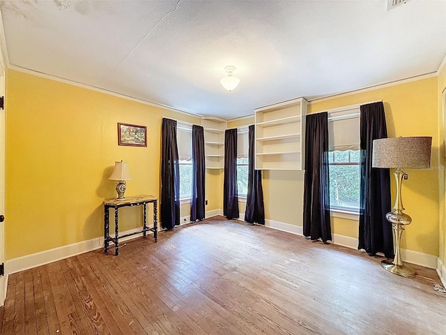 800 W Lake Elbert Dr NE, Winter Haven, FL 33881 - unfurnished bedroom with hardwood / wood-style floors and ornamental molding