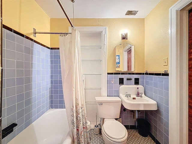800 W Lake Elbert Dr NE, Winter Haven, FL 33881 - full bathroom featuring shower / bath combo, tile walls, wainscoting, and tile patterned flooring