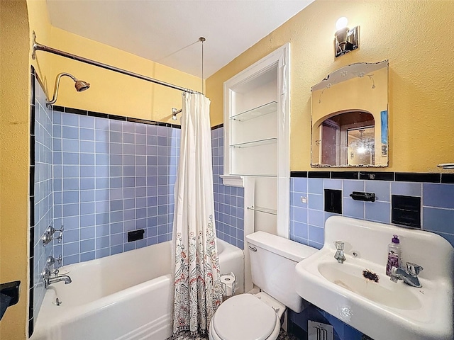 800 W Lake Elbert Dr NE, Winter Haven, FL 33881 - full bathroom featuring shower / bath combination with curtain, tile walls, wainscoting, and a textured wall
