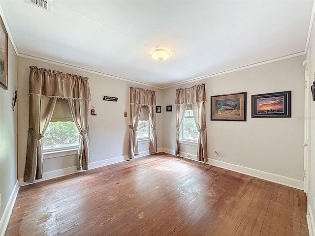 800 W Lake Elbert Dr NE, Winter Haven, FL 33881 - unfurnished room with healthy amount of natural light, crown molding, and wood finished floors