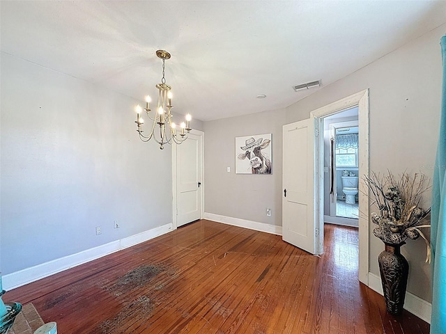 800 W Lake Elbert Dr NE, Winter Haven, FL 33881 - spare room featuring a chandelier and wood-type flooring