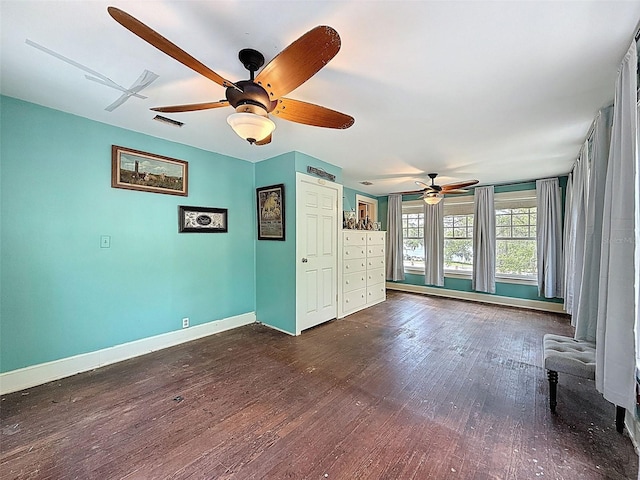800 W Lake Elbert Dr NE, Winter Haven, FL 33881 - unfurnished living room with a ceiling fan, dark wood finished floors, and a baseboard radiator