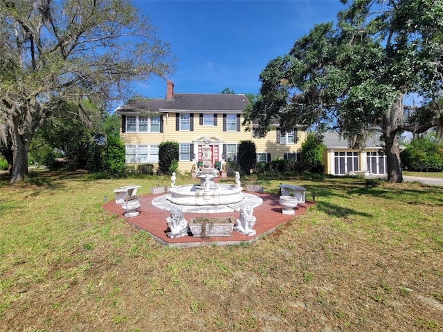800 W Lake Elbert Dr NE, Winter Haven, FL 33881 - back of house featuring a chimney and a lawn