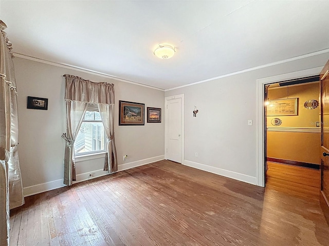 800 W Lake Elbert Dr NE, Winter Haven, FL 33881 - unfurnished room with crown molding and hardwood / wood-style flooring