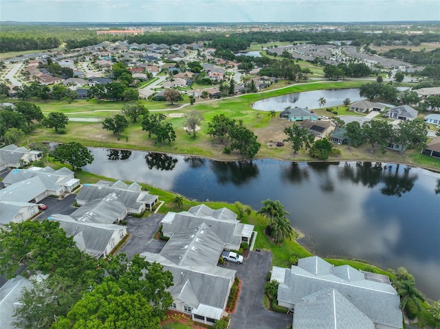 view of property location with nearby suburban area, a large body of water, and a golf club