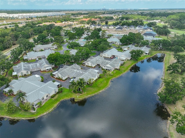 aerial view of property and surrounding area featuring nearby suburban area and a nearby body of water