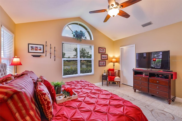 bedroom featuring vaulted ceiling, multiple windows, baseboards, a ceiling fan, and wood finished floors