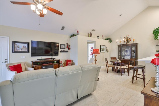 living area featuring ceiling fan, a chandelier, light wood finished floors, and high vaulted ceiling