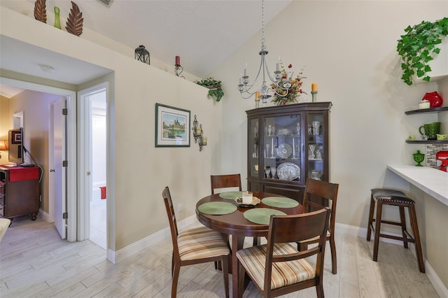 815 Silverthorn Ln Unit 0, Sun City Center, FL 33573 - dining room with light wood-style flooring, vaulted ceiling, and baseboards