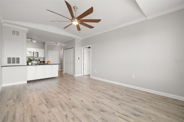 5000 Culbreath Key Way Unit 8-319, Tampa, FL 33611 - unfurnished living room featuring ceiling fan, light wood finished floors, baseboards, and crown molding