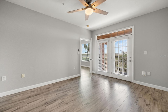 5000 Culbreath Key Way Unit 8-319, Tampa, FL 33611 - empty room with a ceiling fan, baseboards, wood finished floors, and fire sprinkler in ceiling