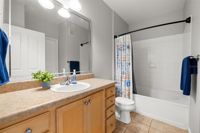 5000 Culbreath Key Way Unit 8-319, Tampa, FL 33611 - bathroom featuring vanity, toilet, shower / bath combination with curtain, and tile patterned floors