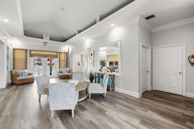 5000 Culbreath Key Way Unit 8-319, Tampa, FL 33611 - living area featuring wood finished floors, crown molding, baseboards, a raised ceiling, and recessed lighting