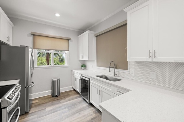 5000 Culbreath Key Way Unit 8-319, Tampa, FL 33611 - kitchen with appliances with stainless steel finishes, a sink, crown molding, light countertops, and white cabinetry