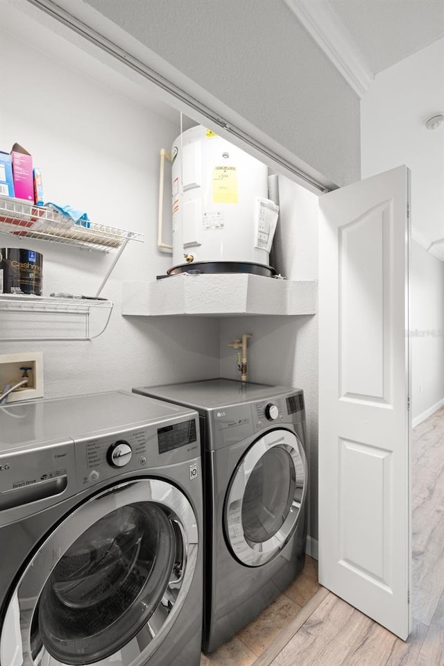 5000 Culbreath Key Way Unit 8-319, Tampa, FL 33611 - washroom featuring washer and dryer, water heater, and light wood-style flooring