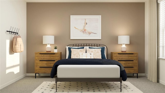 bedroom with light colored carpet and baseboards
