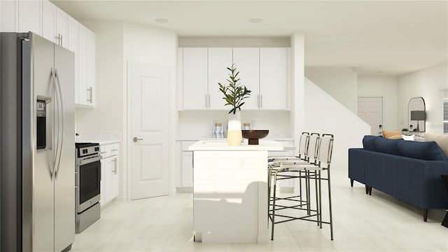 kitchen with a kitchen breakfast bar, range, stainless steel refrigerator with ice dispenser, open floor plan, and white cabinets