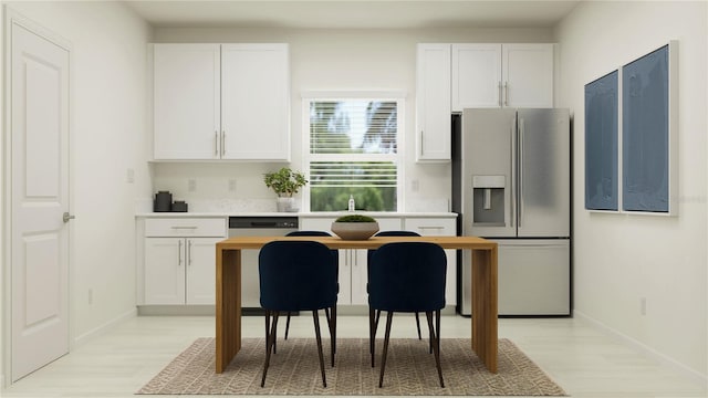 kitchen with white cabinetry, light wood-style floors, and appliances with stainless steel finishes