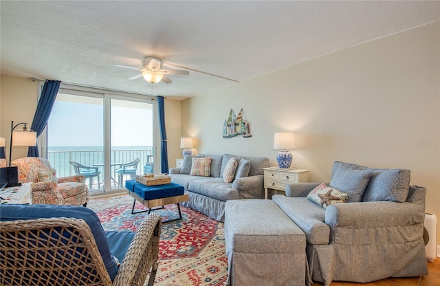 living area featuring a ceiling fan and wood finished floors