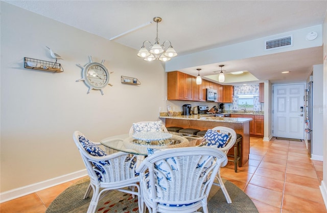 dining area featuring baseboards, an inviting chandelier, visible vents, and light tile patterned flooring