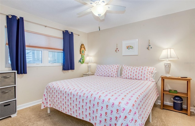 carpeted bedroom with baseboards and a ceiling fan