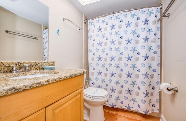 bathroom featuring tile patterned flooring, toilet, a shower with shower curtain, and vanity