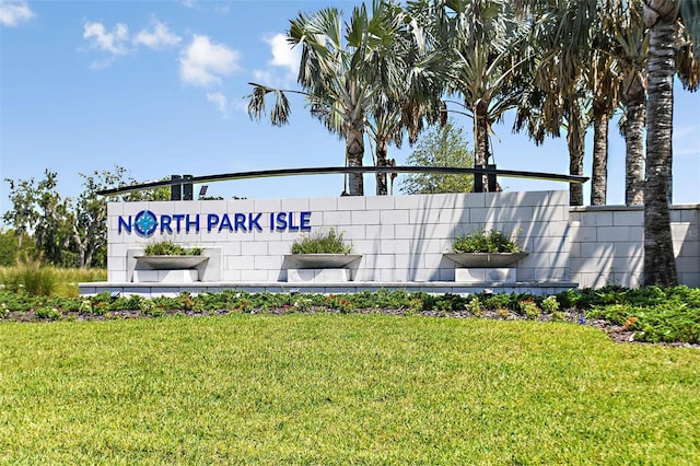 community sign featuring a lawn