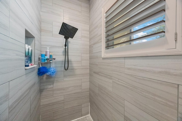 bathroom with a tile shower