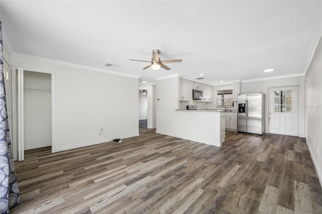 unfurnished living room featuring a ceiling fan, ornamental molding, visible vents, and dark wood-type flooring