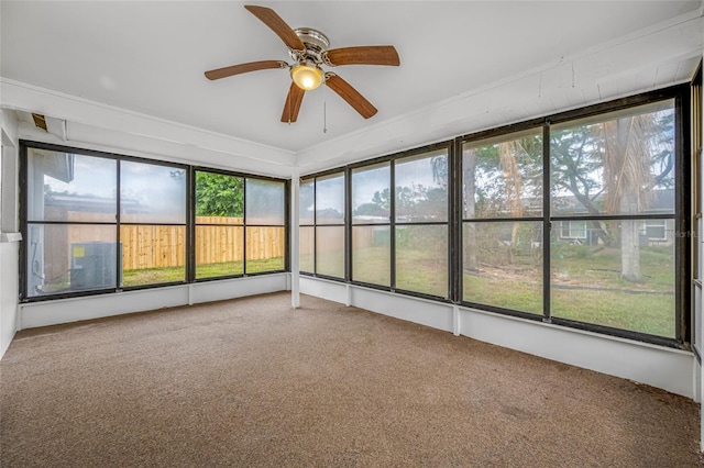unfurnished sunroom with a ceiling fan