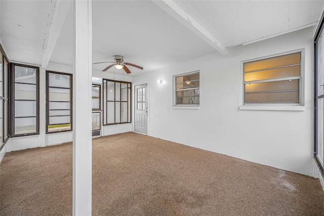 unfurnished sunroom featuring beam ceiling