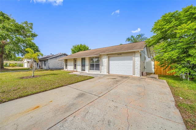 ranch-style home with driveway, fence, a garage, a porch, and a front lawn